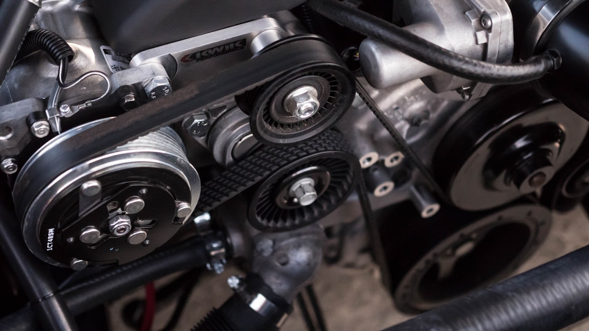 Close-up of an engine bay belt and pulley system
